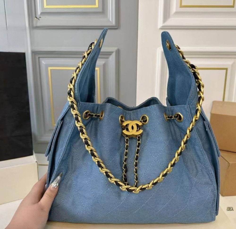 Chanel denim bag in light blue with a gold chain